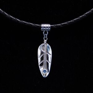 Sterling Silver Feather Pendant On Woven Leather Cord